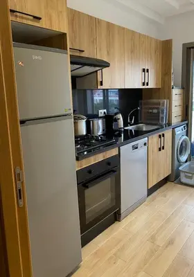 a kitchen with a refrigerator and a stove at Sidi Rahal beach apartment Heaven beach in Sidi Rahal