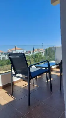 a chair sitting on top of a balcony at Sidi Rahal beach apartment Heaven beach in Sidi Rahal