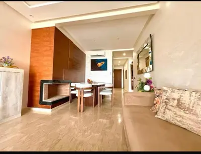 a living room with a table and a couch at Marco in Casablanca