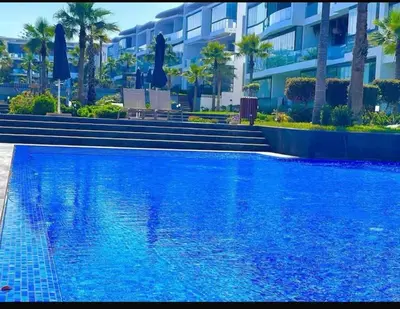 a large blue swimming pool in front of a building at Marco in Casablanca