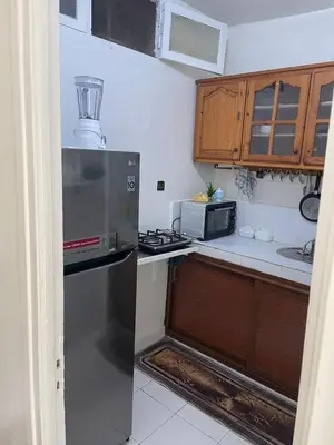 a kitchen with a stainless steel refrigerator and cabinets at Cozy Studio in Diour Jammae in Rabat