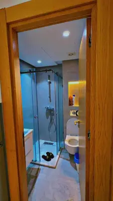 a bathroom with a glass shower and a toilet at Les terrace d'anfa in Casablanca