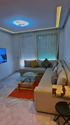 a living room with a couch and a table at Les terrace d'anfa in Casablanca