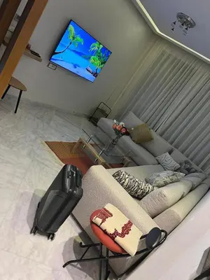 a living room with a couch and a flat screen tv at Les terrace d'anfa in Casablanca