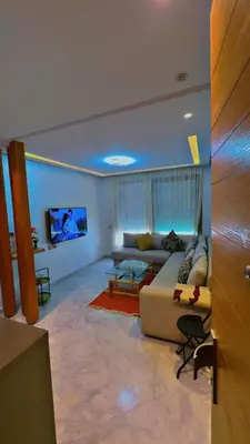 a living room with a couch and a tv at Les terrace d'anfa in Casablanca