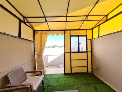 an empty room with a door and a room with green grass at Newly Apartment refurbished central calm charming in Rabat