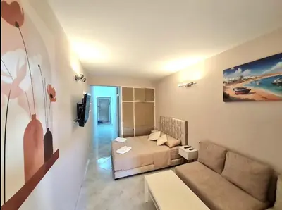 a small living room with a couch and a bed at Newly Apartment refurbished central calm charming in Rabat