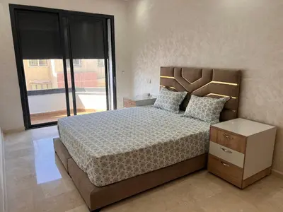 a bedroom with a large bed and a large window at Hay laymoun oulfa casablanca Appartement laimoun in Anfa