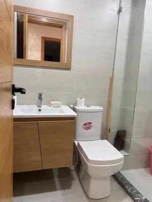 a bathroom with a toilet and a sink and a mirror at Hay laymoun oulfa casablanca Appartement laimoun in Anfa