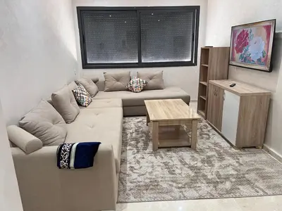 a living room with a couch and a table at Hay laymoun oulfa casablanca Appartement laimoun in Anfa