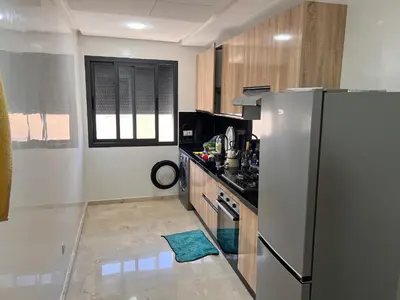 a kitchen with a refrigerator and a counter top at Hay laymoun oulfa casablanca Appartement laimoun in Anfa