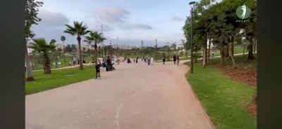 a group of people walking down a path in a park at Hay laymoun oulfa casablanca Appartement laimoun in Anfa