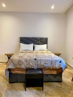 a bedroom with a large bed with two pillows at Social apartment in Rabat