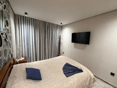 a bedroom with a bed and a flat screen tv at MetroSuite in Casablanca