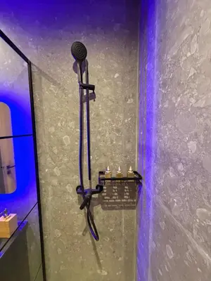 a shower with a microphone on a wall at MetroSuite in Casablanca