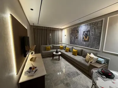a living room with a couch and a table at MetroSuite in Casablanca