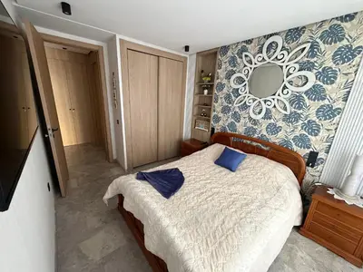 a bedroom with a bed with a mirror on the wall at MetroSuite in Casablanca