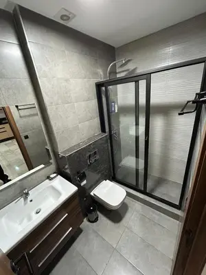 a bathroom with a shower and a toilet and a sink at Résidence Natura Living in Mohammedia