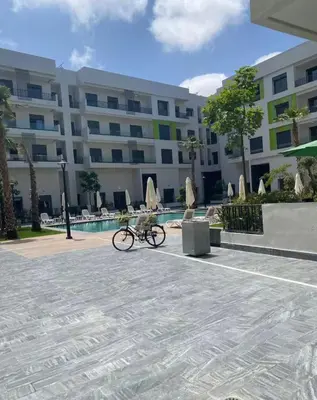 a bike parked in front of a building at Résidence Natura Living in Mohammedia