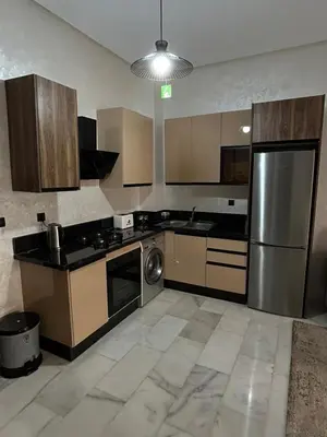 a kitchen with a stainless steel refrigerator and a dishwasher at Résidence Natura Living in Mohammedia