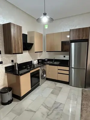 a large kitchen with a stainless steel refrigerator at Résidence Natura Living in Mohammedia