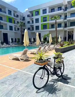 a bike parked in front of a swimming pool at Résidence Natura Living in Mohammedia