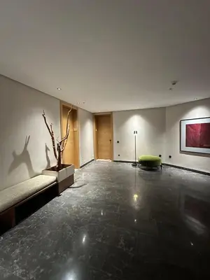 a large room with a couch and a plant on the wall at The Stay of Dreams - Sea View and Pool Access in Casablanca