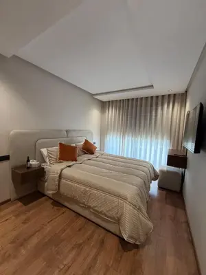 a bedroom with a large bed and a large window at Cosy cocon central in Le Polo