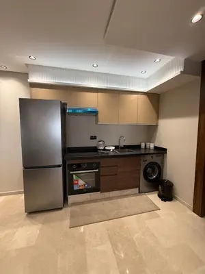 a kitchen with a stainless steel refrigerator and a dishwasher at Cosy cocon central in Le Polo