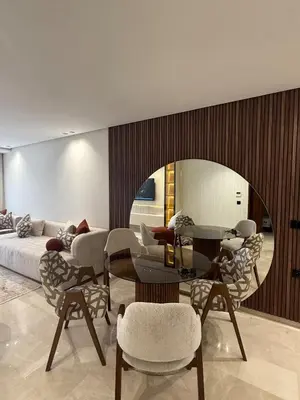 a living room with a table and chairs and a couch at Cosy cocon central in Le Polo