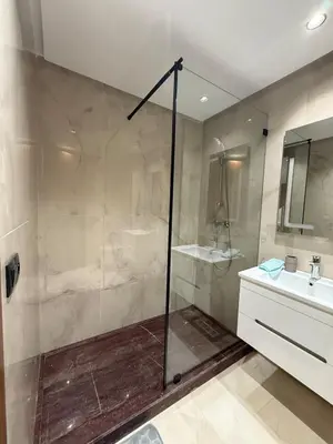a bathroom with a shower and a sink at Cosy cocon central in Le Polo