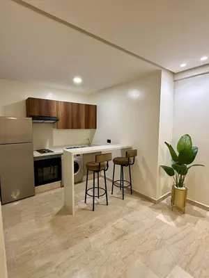 a kitchen with a counter and stools in it at Modern studio in Burgundy in Casablanca-Port