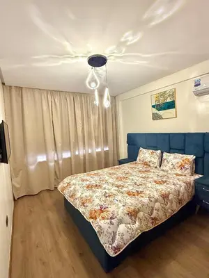 a bedroom with a bed with a blue headboard at Modern studio in Burgundy in Casablanca-Port