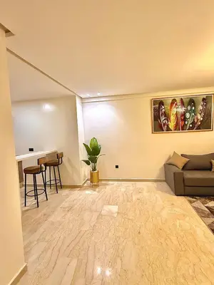a living room with a couch and a table at Modern studio in Burgundy in Casablanca-Port