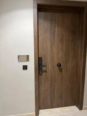 a wooden door with a sign on a wall at Modern studio in Burgundy in Casablanca-Port