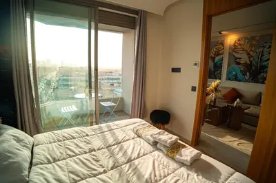 a bedroom with a bed and a view of a balcony at Skyline View Luxury Private Parking - Netflix in Casablanca