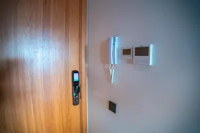 a refrigerator with a phone on it next to a door at Skyline View Luxury Private Parking - Netflix in Casablanca