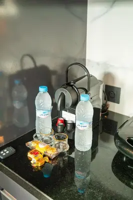 two bottles of water and containers of food on a kitchen counter at Skyline View Luxury Private Parking - Netflix in Casablanca