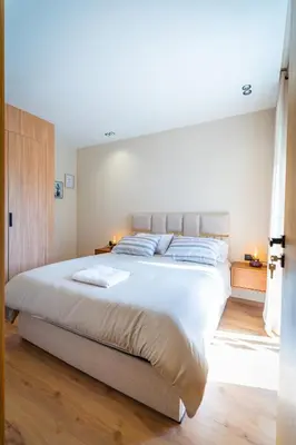 a bedroom with a large bed with white sheets at CFC Skyline View Luxury Private Parking - Netflix in Casablanca