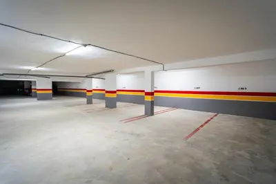 an empty parking garage with red yellow and white walls at CFC Skyline View Luxury Private Parking - Netflix in Casablanca
