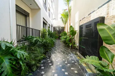 a courtyard of a building with plants and a walkway at CFC Skyline View Luxury Private Parking - Netflix in Casablanca