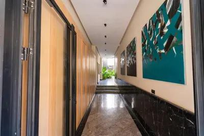 a hallway with wooden walls and a long hallway with paintings at CFC Skyline View Luxury Private Parking - Netflix in Casablanca