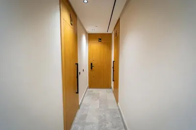 a hallway with two wooden doors and a tile floor at CFC Skyline View Luxury Private Parking - Netflix in Casablanca