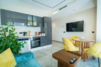 a kitchen and living room with a couch and a table at CFC Skyline View Luxury Private Parking - Netflix in Casablanca
