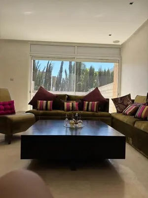 a living room with a couch and a coffee table at Villa de luxe CGI avec piscine in Bouskoura