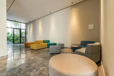 a waiting room with colorful chairs and a table at CFC business, Coworking, gym, self check-in in Casablanca
