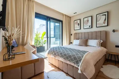 a bedroom with a bed and a desk and a window at CFC business, Coworking, gym, self check-in in Casablanca