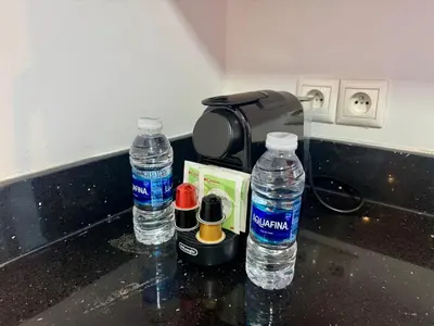 three bottles of water are sitting on a counter at CityZen Suites, Luxury 3BR near Mohamed V Stadium in Maarif