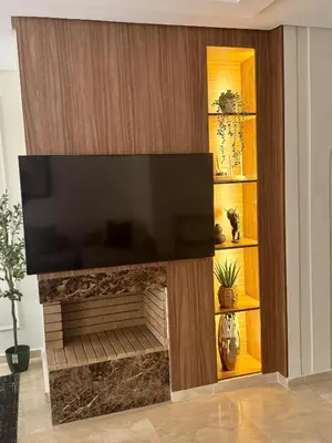 a living room with a fireplace with a flat screen tv at CityZen Suites, Luxury 3BR near Mohamed V Stadium in Maarif