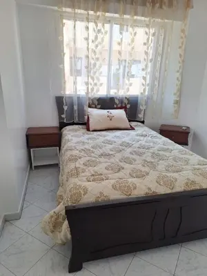 a bedroom with a bed and a window with curtains at Appartement cosy à Rabat Mer et commodités à pied in Rabat